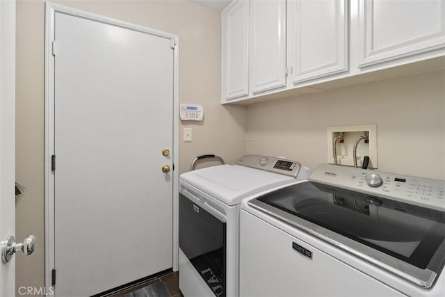 clothes washing area featuring cabinet space and washing machine and clothes dryer