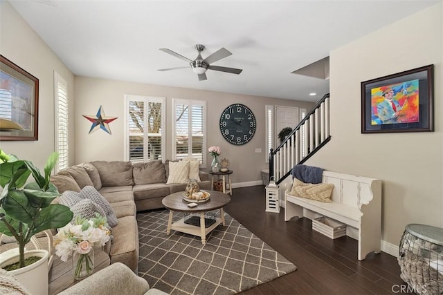 living room with a healthy amount of sunlight, stairs, baseboards, and wood finished floors