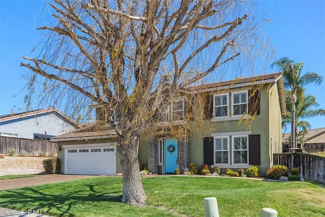 view of front of home with stucco siding, an attached garage, a front yard, and fence