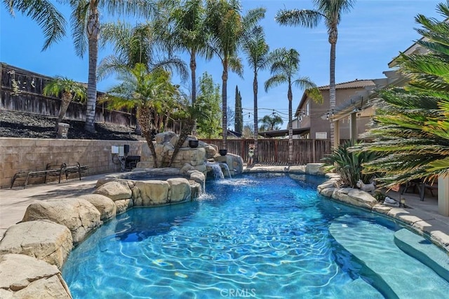 view of pool with an in ground hot tub, a fenced backyard, and a fenced in pool