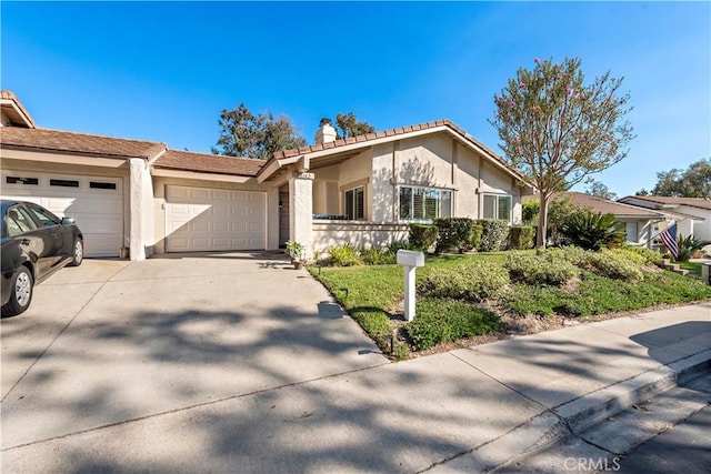 ranch-style house featuring stucco siding, driveway, a chimney, and an attached garage