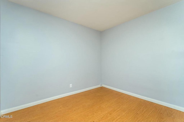 unfurnished room featuring light wood-type flooring and baseboards