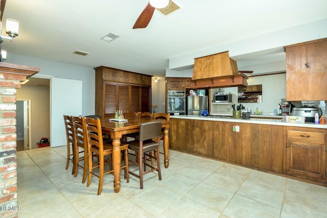 dining area with light tile patterned floors, visible vents, and ceiling fan