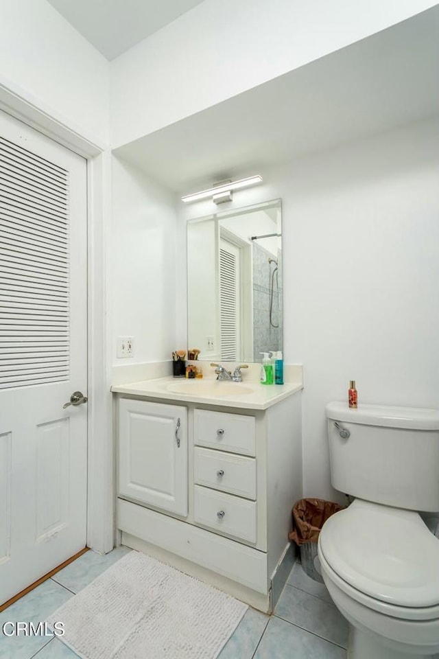 full bath featuring tile patterned floors, toilet, walk in shower, and vanity