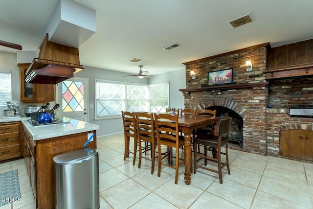 dining area with light tile patterned floors, visible vents, and a healthy amount of sunlight