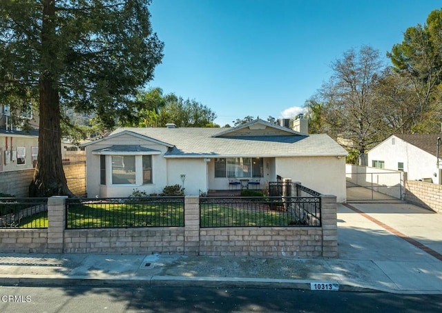 view of front of house with a fenced front yard, a front yard, covered porch, stucco siding, and driveway