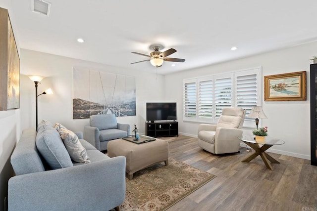 living room featuring visible vents, a ceiling fan, recessed lighting, light wood-style floors, and baseboards