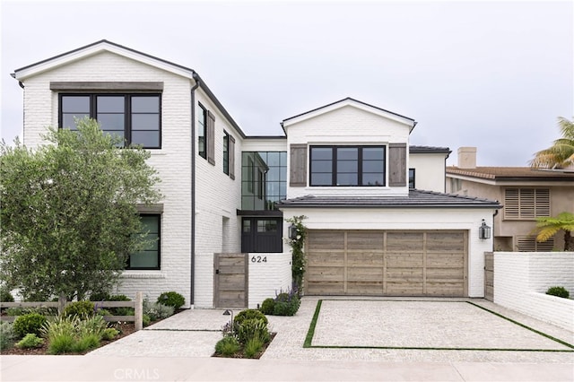 view of front of home featuring brick siding and concrete driveway