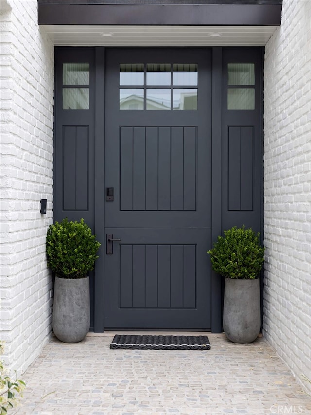 property entrance with brick siding and french doors