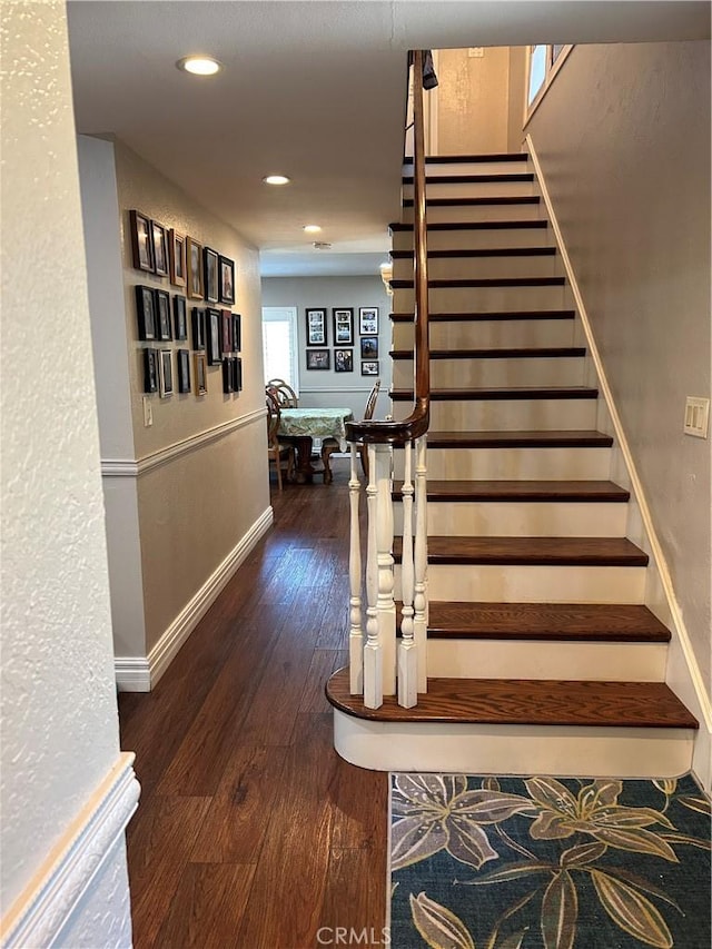 staircase with recessed lighting, baseboards, and wood-type flooring