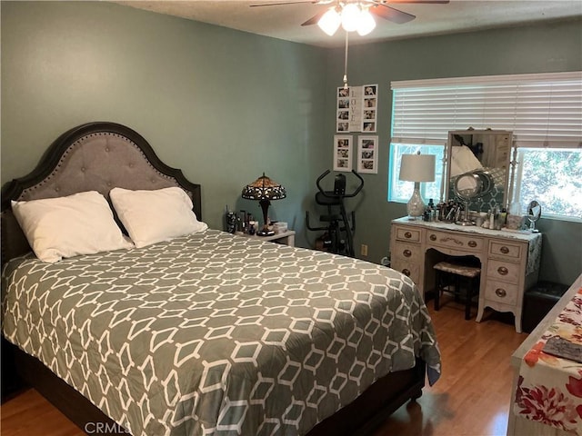bedroom featuring wood finished floors and a ceiling fan