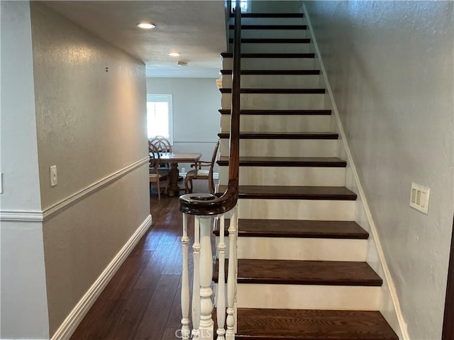 staircase featuring recessed lighting, baseboards, and hardwood / wood-style floors