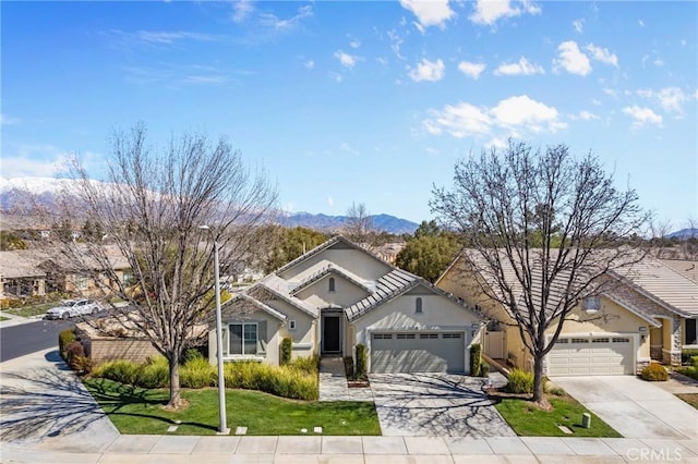 ranch-style house featuring an attached garage, stucco siding, concrete driveway, a front lawn, and a tile roof