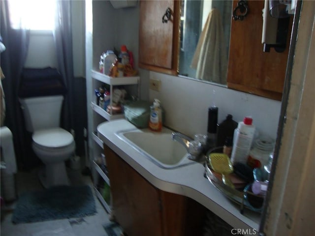 bathroom featuring toilet and vanity