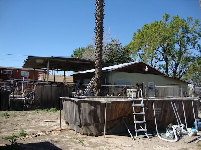 back of property featuring fence