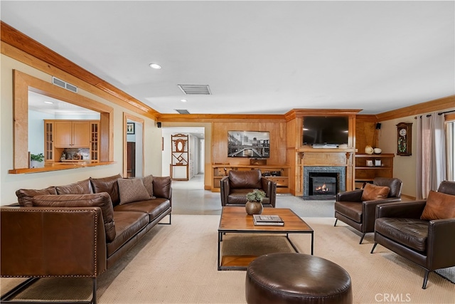 living room featuring visible vents, recessed lighting, light colored carpet, and a glass covered fireplace