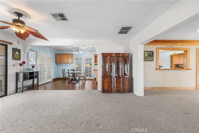 entrance foyer featuring french doors, carpet floors, visible vents, and ceiling fan