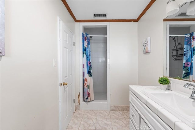 bathroom featuring vanity, crown molding, visible vents, and a shower stall