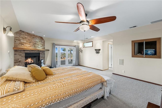 carpeted bedroom featuring visible vents, a ceiling fan, a stone fireplace, baseboards, and access to exterior