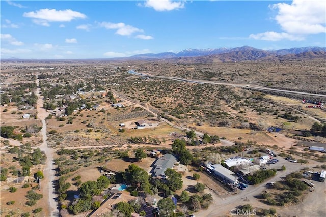 birds eye view of property featuring a desert view and a mountain view