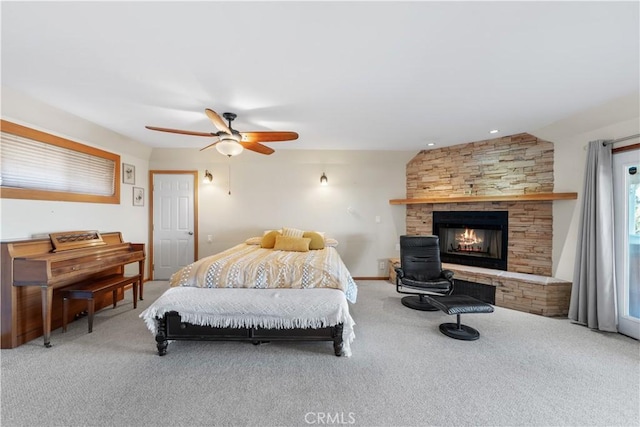 bedroom with a ceiling fan, a fireplace, and carpet floors