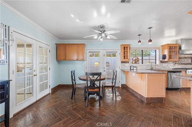 kitchen with glass insert cabinets, wall chimney range hood, dishwasher, french doors, and a peninsula