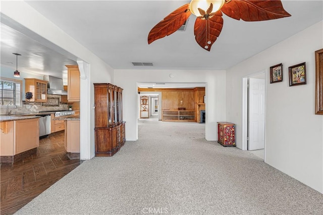 interior space featuring visible vents, a ceiling fan, and dark colored carpet