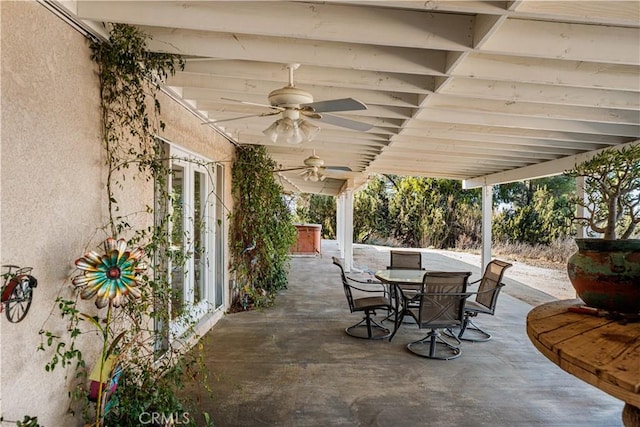 view of patio featuring outdoor dining area, a ceiling fan, and french doors