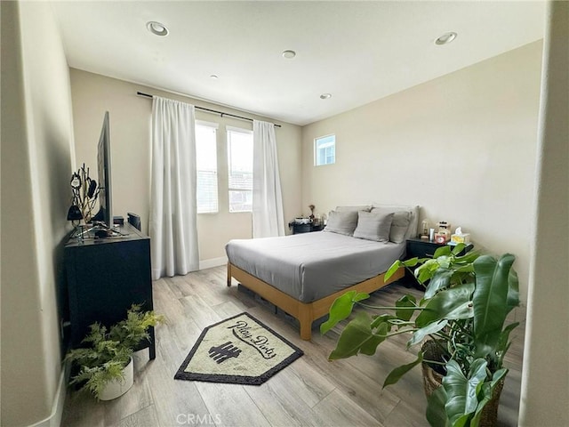 bedroom featuring recessed lighting, wood finished floors, and baseboards