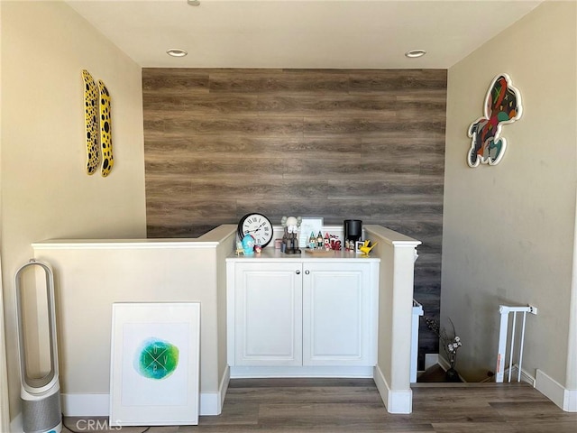 interior space with baseboards and wood finished floors