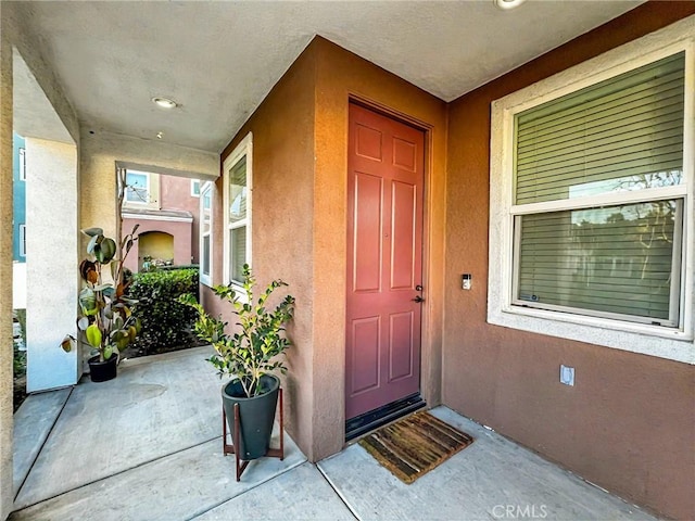 entrance to property with stucco siding