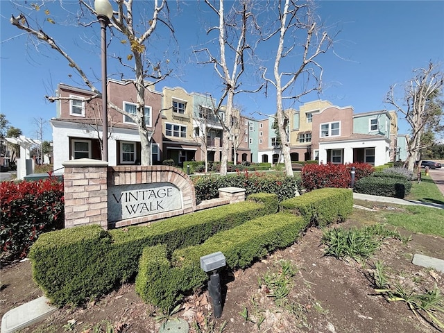 community / neighborhood sign featuring a residential view