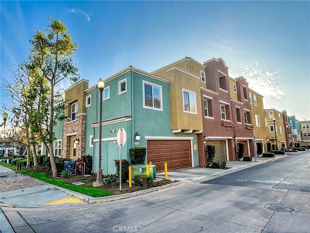 view of property featuring a residential view and an attached garage