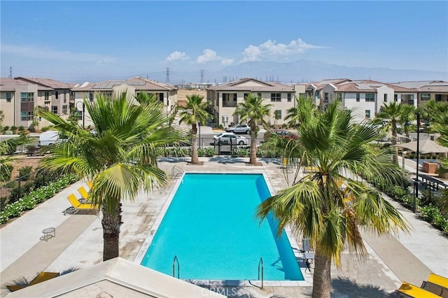 community pool with a residential view and fence