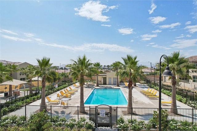 community pool featuring a patio area and fence