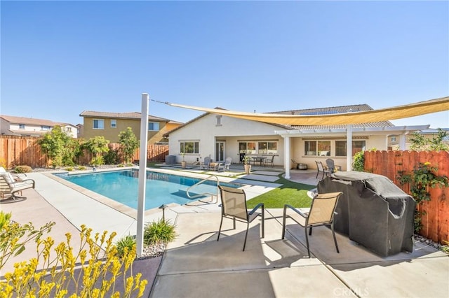 view of pool with a fenced in pool, area for grilling, a fenced backyard, and a patio area