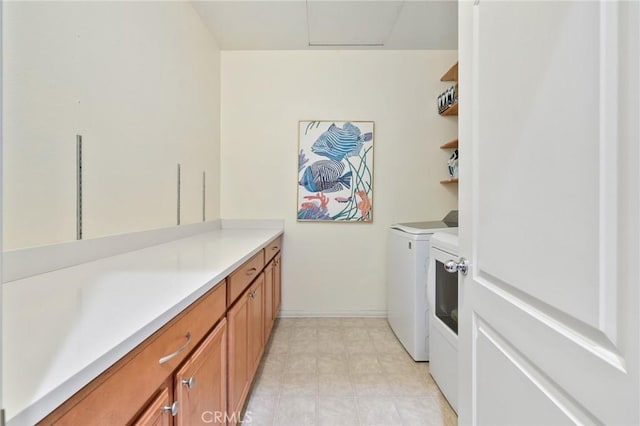 laundry room with cabinet space, separate washer and dryer, and baseboards