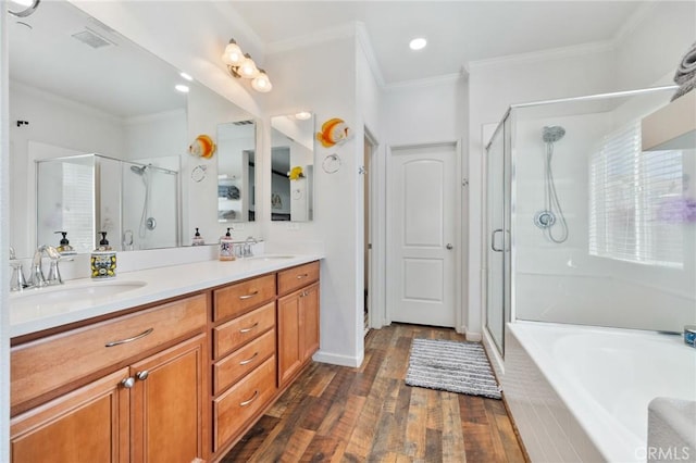 bathroom with a sink, a shower stall, and crown molding