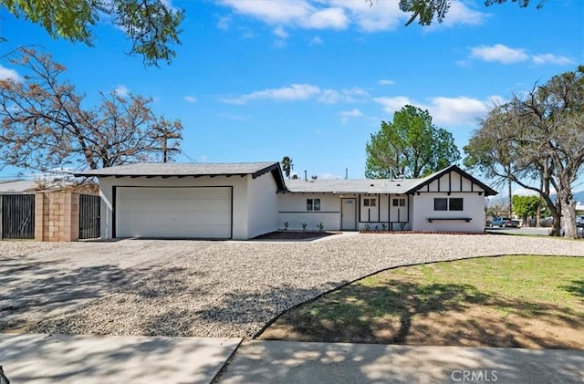 view of front of house with stucco siding, driveway, and a garage