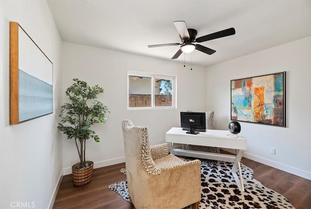 office space featuring a ceiling fan, wood finished floors, and baseboards