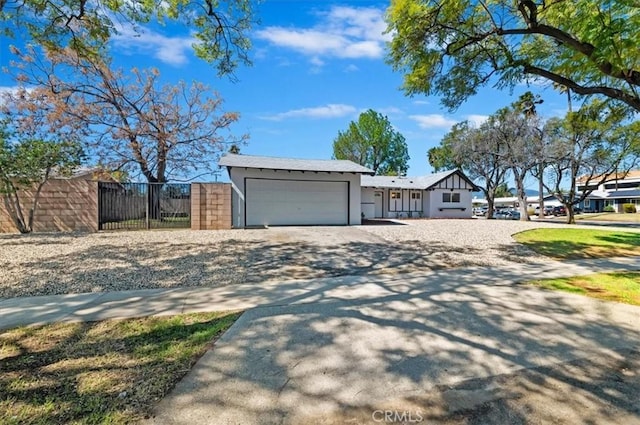 exterior space featuring a garage, driveway, and fence