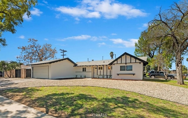 view of front of property featuring a garage and a front yard