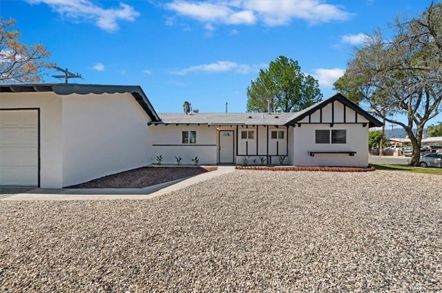 back of house featuring stucco siding and an attached garage