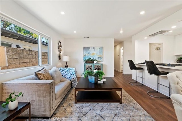 living area with recessed lighting, baseboards, and wood finished floors