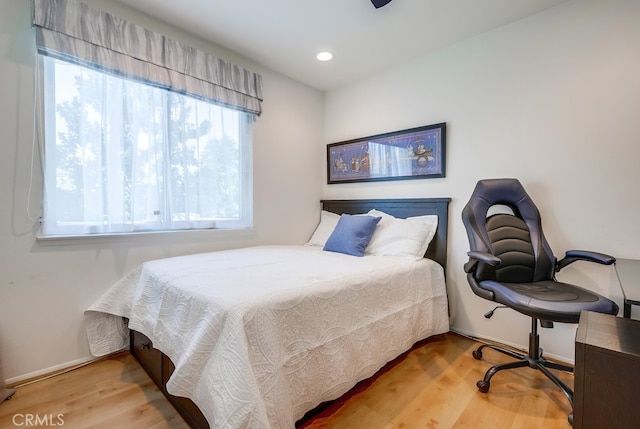 bedroom with recessed lighting, baseboards, and wood finished floors