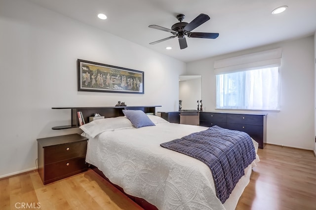 bedroom with recessed lighting, baseboards, and light wood-style floors