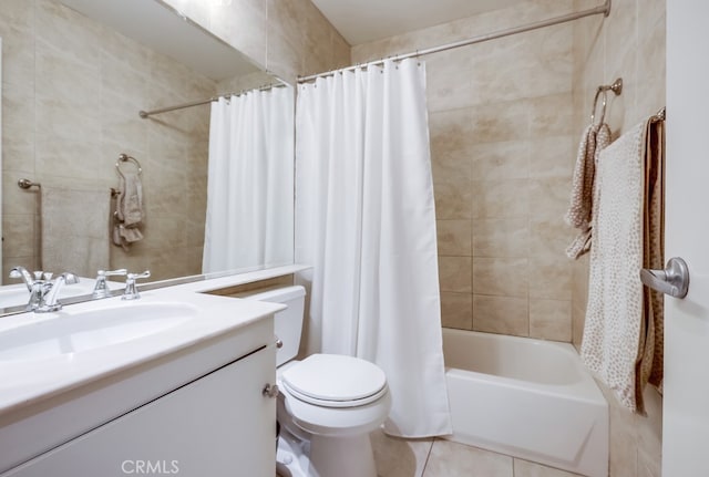 full bathroom featuring toilet, shower / tub combo with curtain, tile walls, tile patterned flooring, and vanity