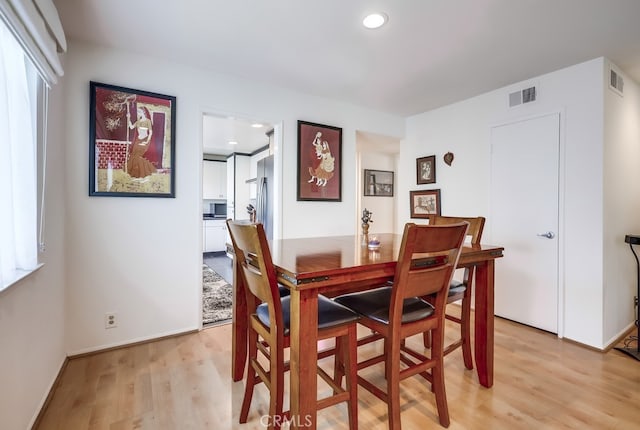 dining space with recessed lighting, visible vents, baseboards, and light wood finished floors