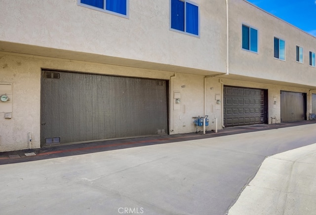 exterior space with stucco siding and a garage