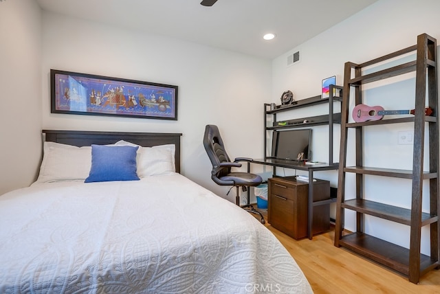 bedroom with recessed lighting, wood finished floors, and visible vents